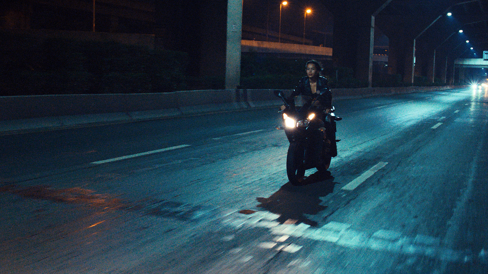 Rita-Ora-x-Tiago-PZK-x-Robin-Schulz-Ill-Be-There-bike-by-Robert-Wunsch Girl riding a motorcycle at night.