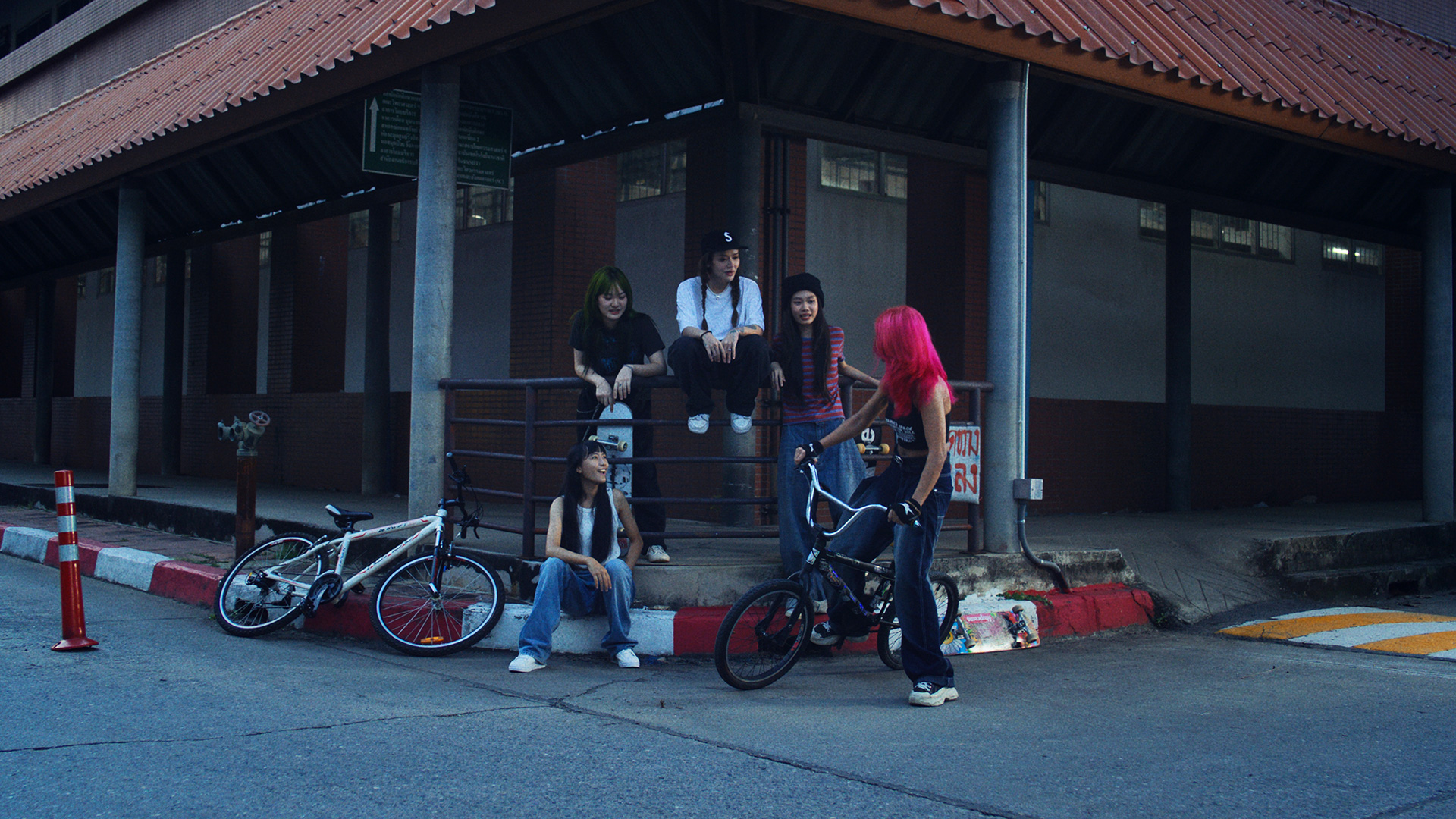 Rita-Ora-x-Tiago-PZK-x-Robin-Schulz-Ill-Be-There-girls-by-Robert-Wunsch Girl hanging out in the hood with bicycles.
