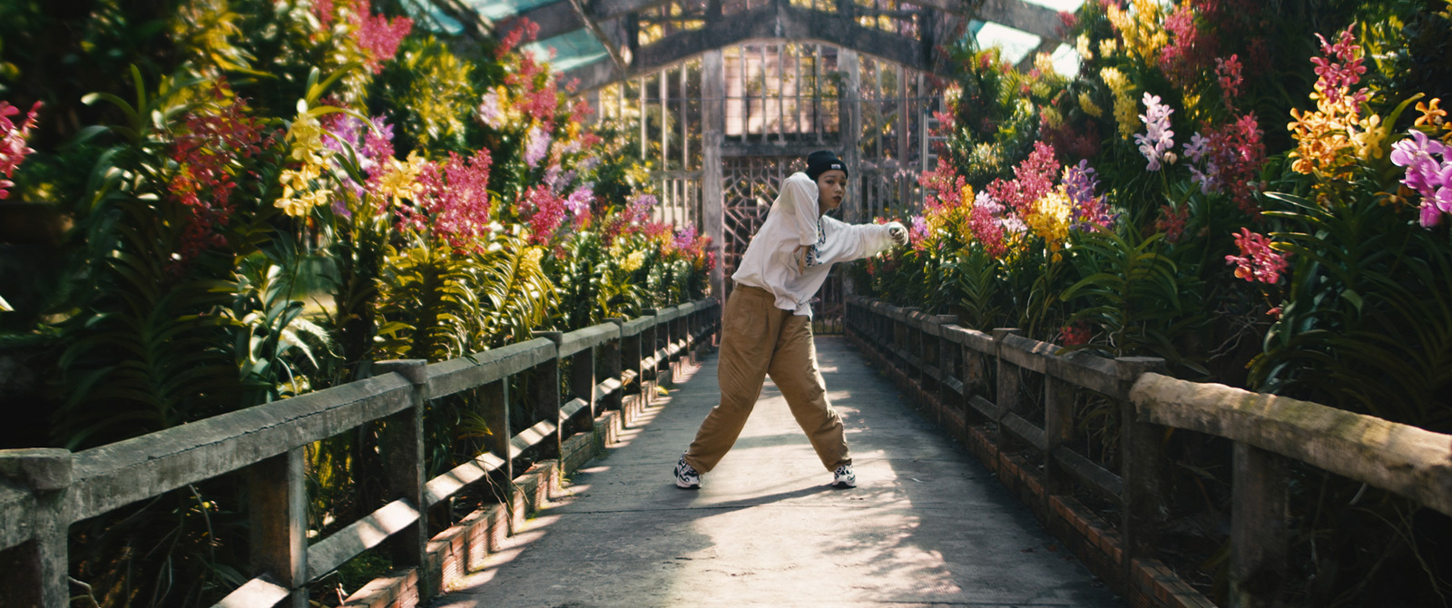 Robin-Schulz-Ft-Wes-Alane-dance-flowers-by-Robert-Wunsch Girl in streetwear outfit dancing in a flower garden.