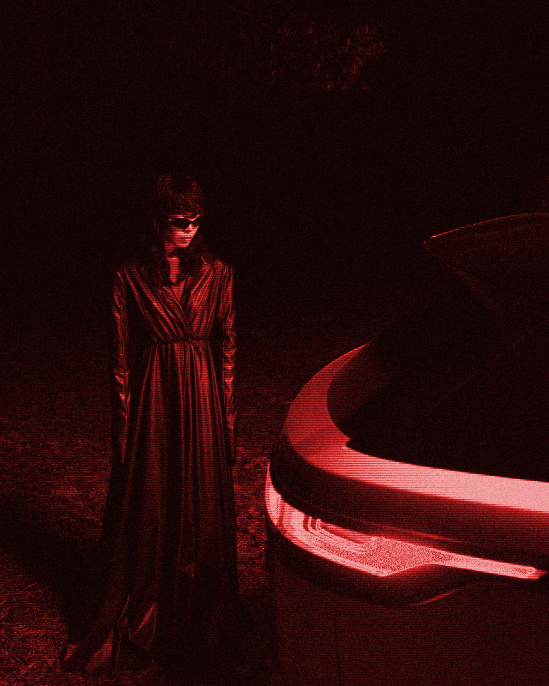 Robert-Wunsch-portfolio-range-rover-MFPA-campaign-red Girl in a black leather coat looking towards the back light of a Range Rover Velar.